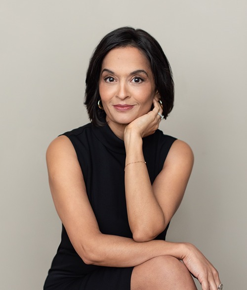 Dr. Aditi Nerurkar, Harvard physician and stress expert, smiling in a black dress with an approachable expression.