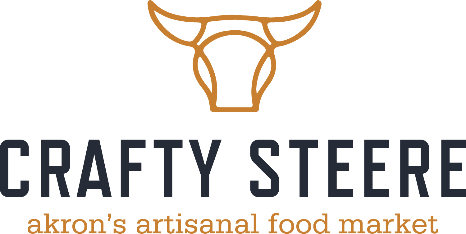 Logo for Crafty Steere: a stylized orange cow head above bold dark text, with 'akron's artisanal food market' in orange beneath.