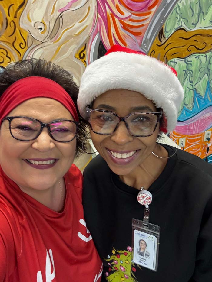 Two Coleman staff members enjoy a holiday party