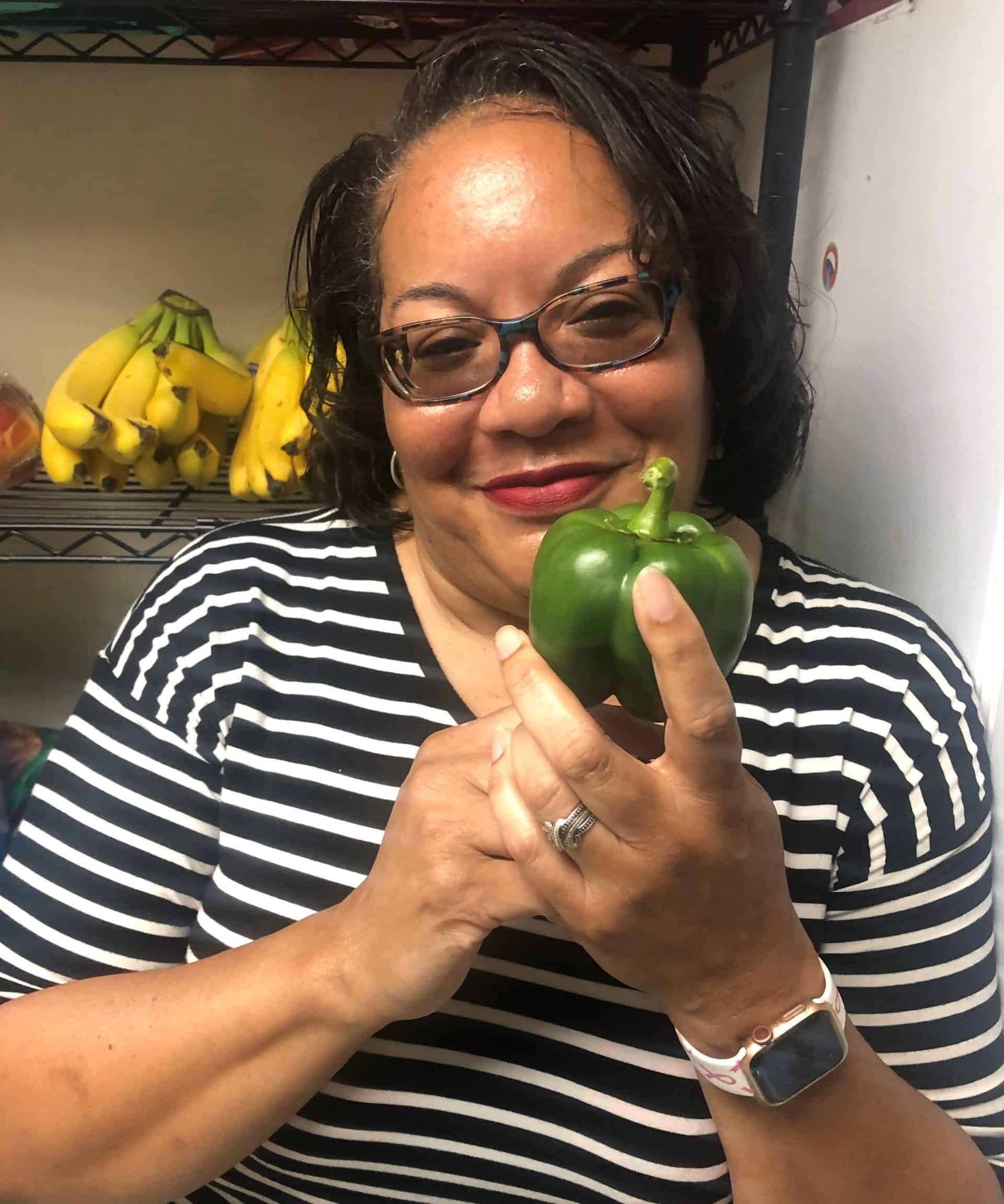 Rhonda Jones holds a green pepper
