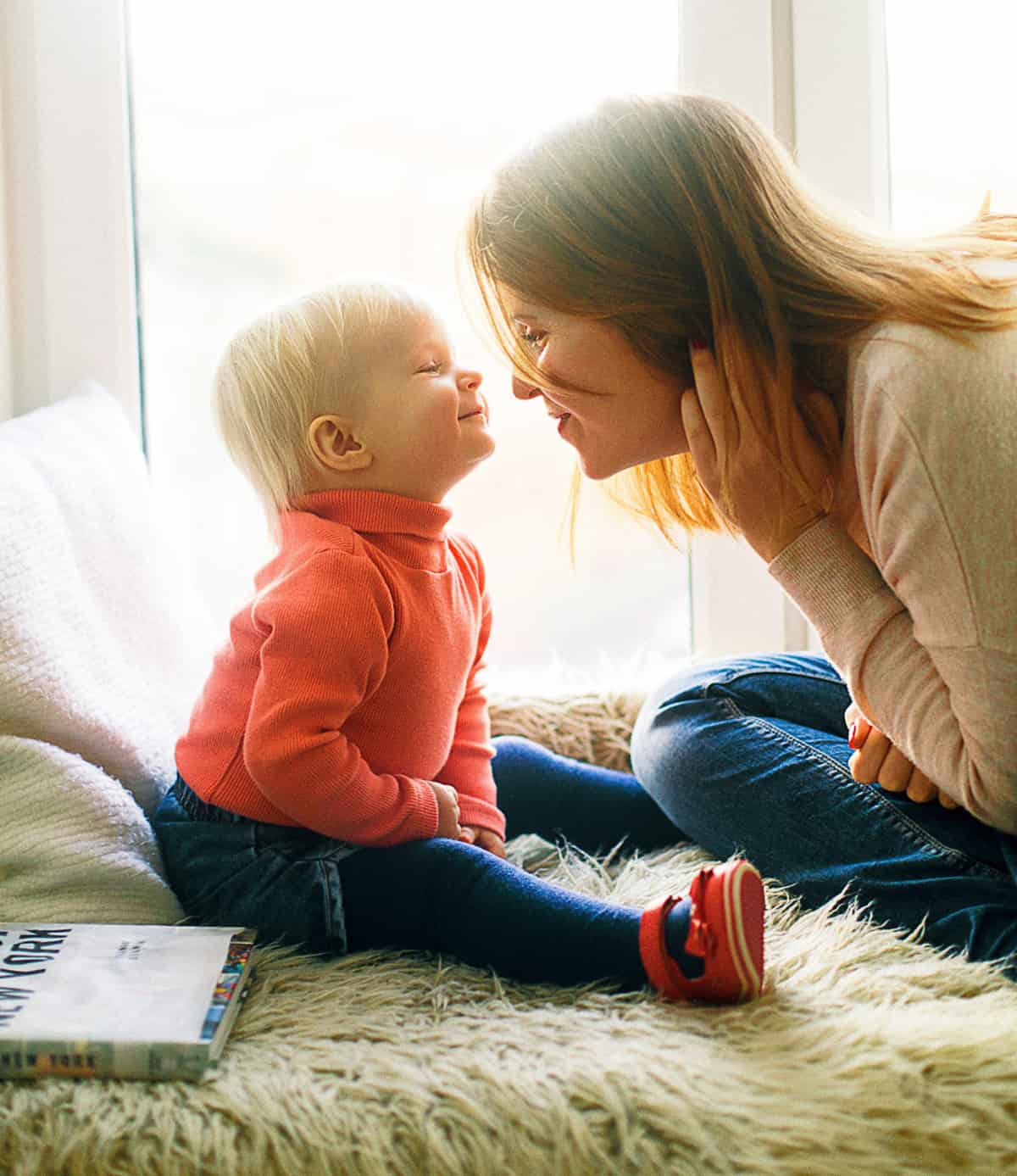 Ways-to-give A mother and baby lean in towards each other with smiles.